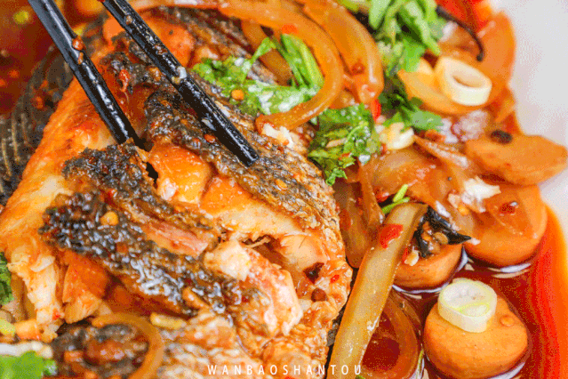 Grilled fish shop - shovel served and grilled fish with a steel tube Grilled fish shop - shovel served and grilled fish with a steel tube