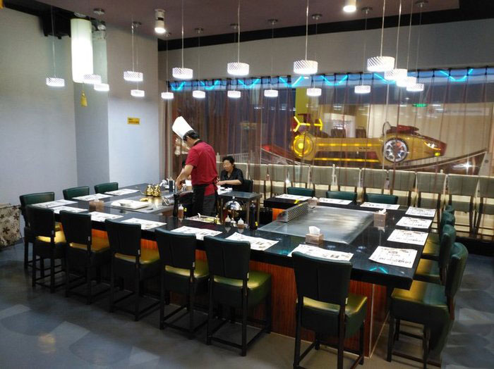 Chef Creates Culinary Masterpieces on Teppanyaki Grill Table at Food Festival